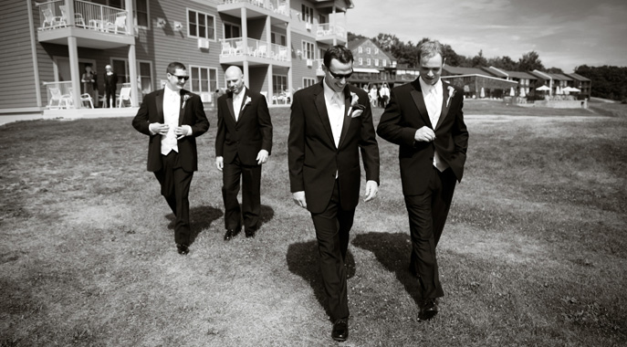 A groom and his best men walk towards their outdoor ceremony at Steele Hill
