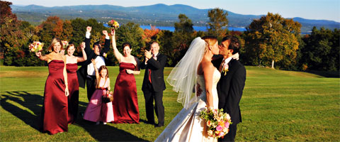 A wedding kiss with a backdrop of lakes and mountains.